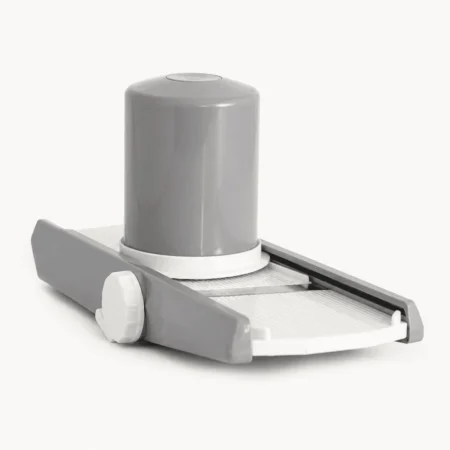 Vegetable slicer chopper standing upright on a plain background