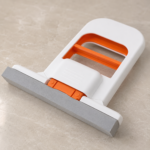 Mini sponge mop cleaning water drops off a tiled wall