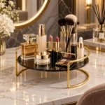 Golden cosmetic storage tray with makeup brushes and perfume bottles on a vanity