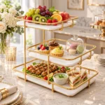 Golden 3 tier serving stand displaying fresh fruits and buffet items