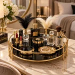 Round gold vanity tray holding reed diffuser bottles and floral decor
