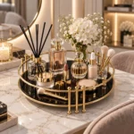 Round gold vanity tray with perfume bottles styled in a bright white room
