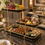 Golden 3 tier buffet and dessert display rack set up on a dining table with fruits