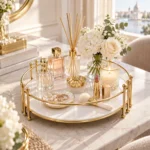 Close up of round gold vanity tray with cosmetic and perfume bottles