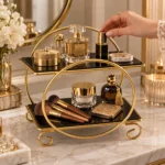 Golden 2 tier cosmetic rack displaying perfume bottles and skincare jars on a vanity