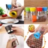 Manual glass salt and pepper grinder in four views: twisting the cap, assorted cap colours, filling and seasoning a steak